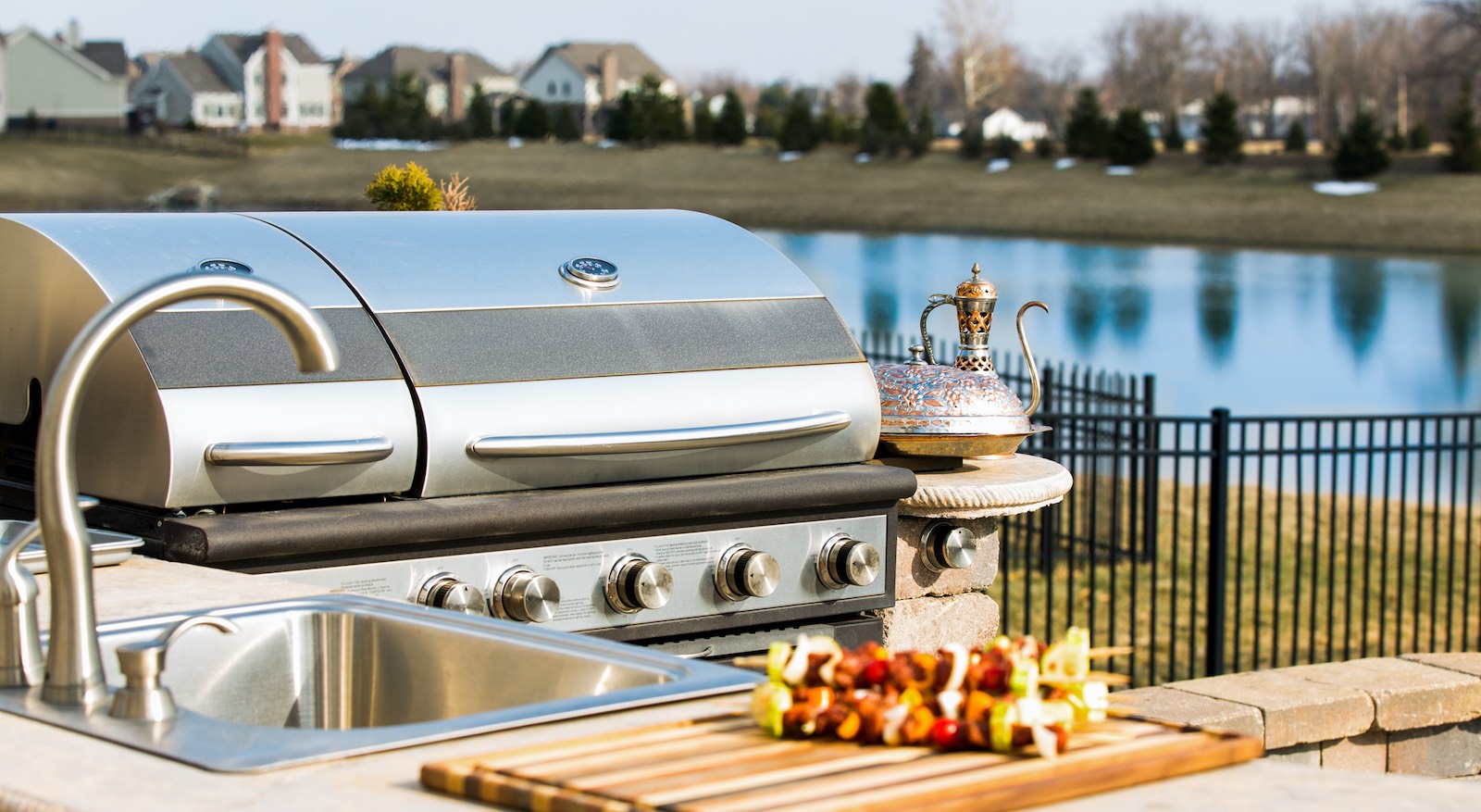 Outdoor kitchen with barbecue and sink on a lake